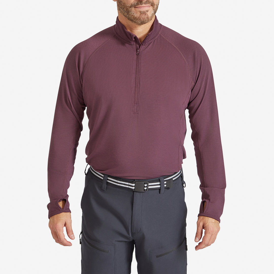 Man wearing a Genus Men's Prune Damson Eden Zip neck Top tucked in