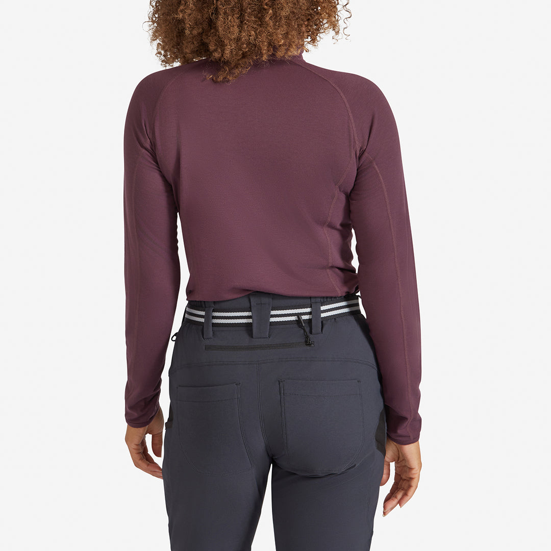 Back view of a tucked in Genus Women's Prune Damson Eden Zip Neck Top 