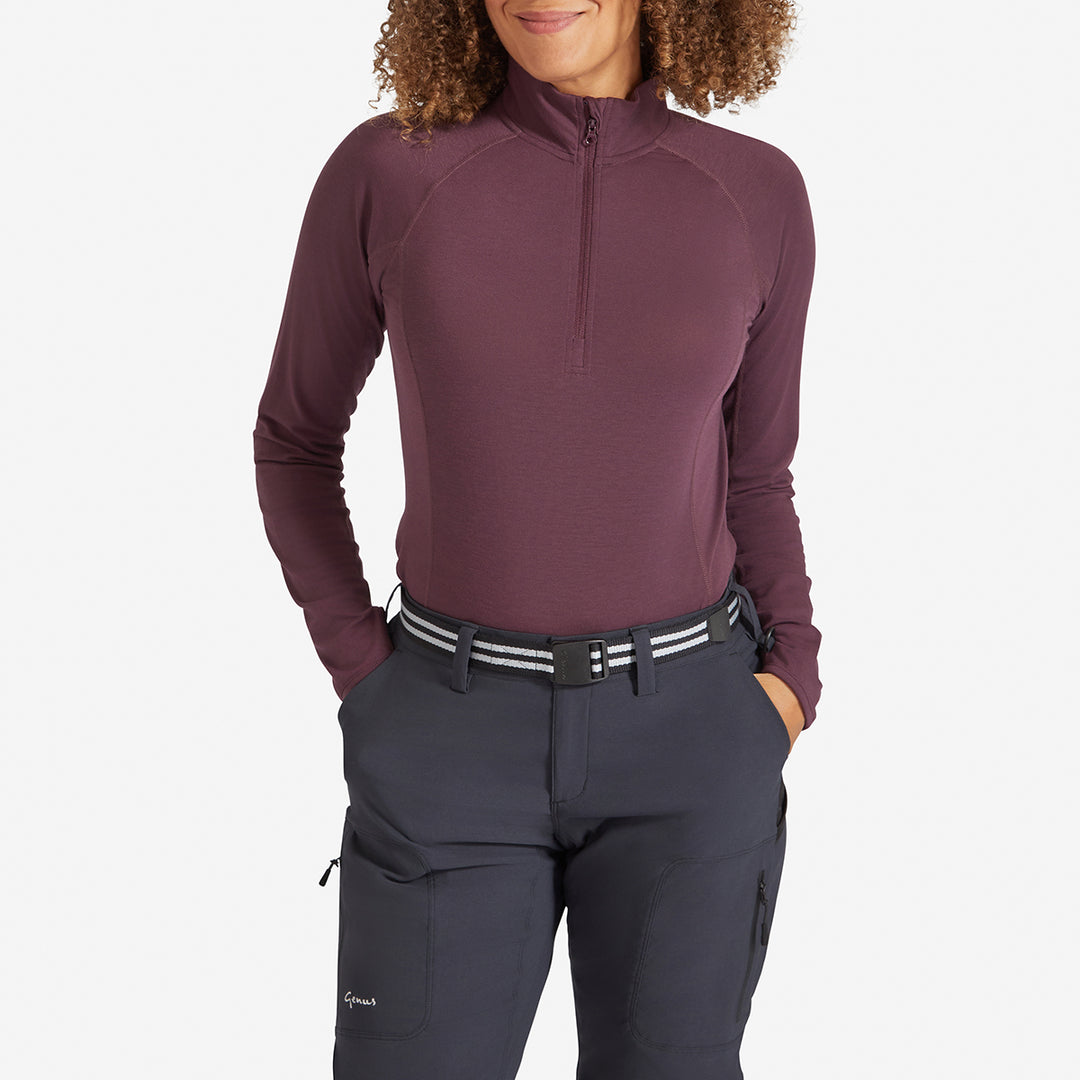 Woman wearing a Genus Women's Prune Damson Eden Zip Neck Top tucked in