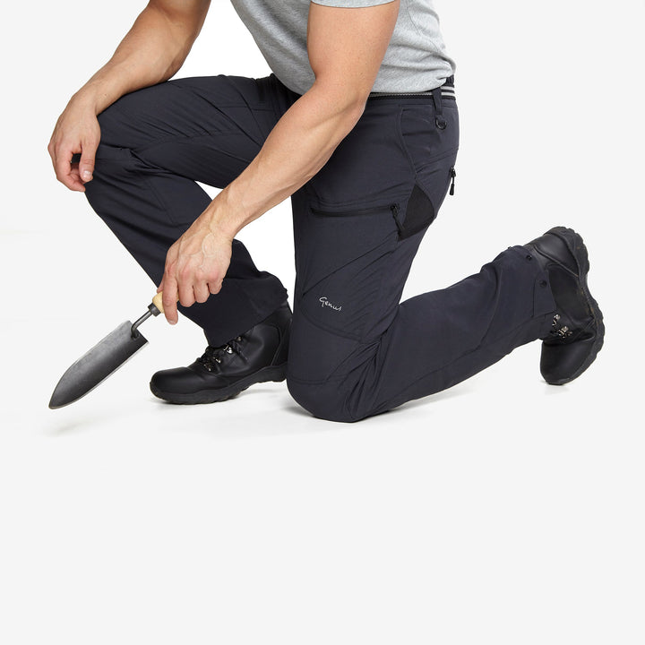 Man kneeling down wearing a pair of Genus Men's 3 Season Midnight Trousers