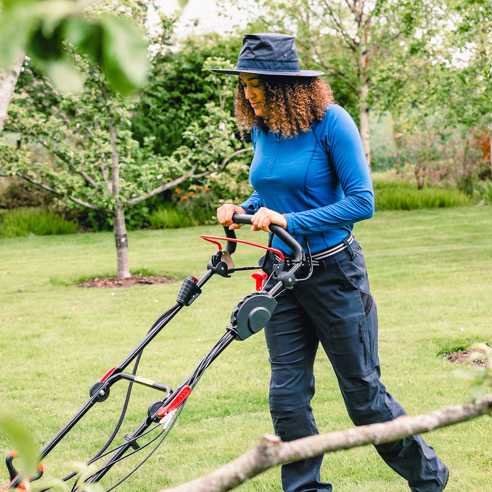 Woman in her garden wearing a Genus Showerproof Gardening Hat