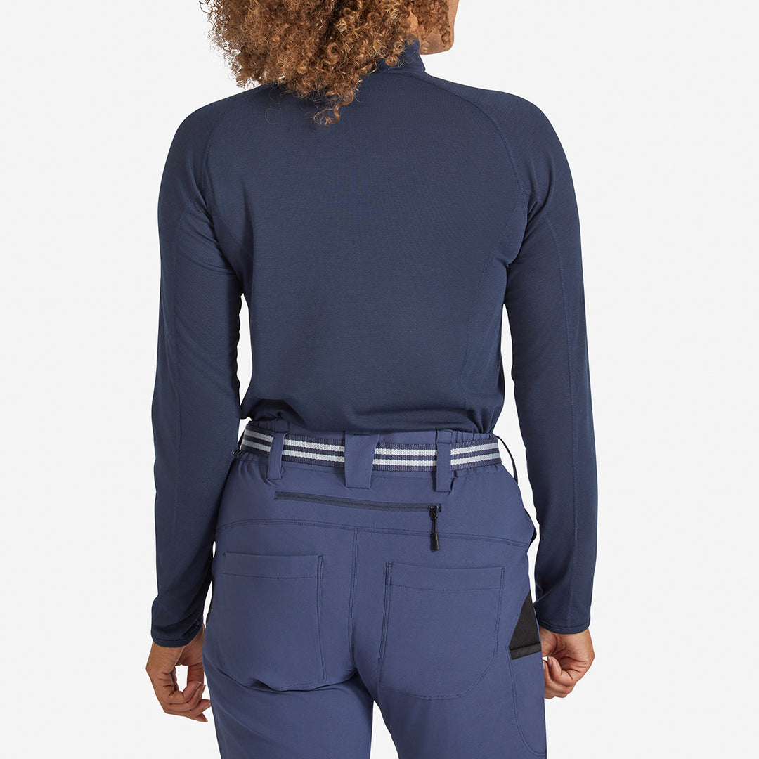 Woman showing the back view of a Genus Women's Marine Blue Eden Zip neck Top