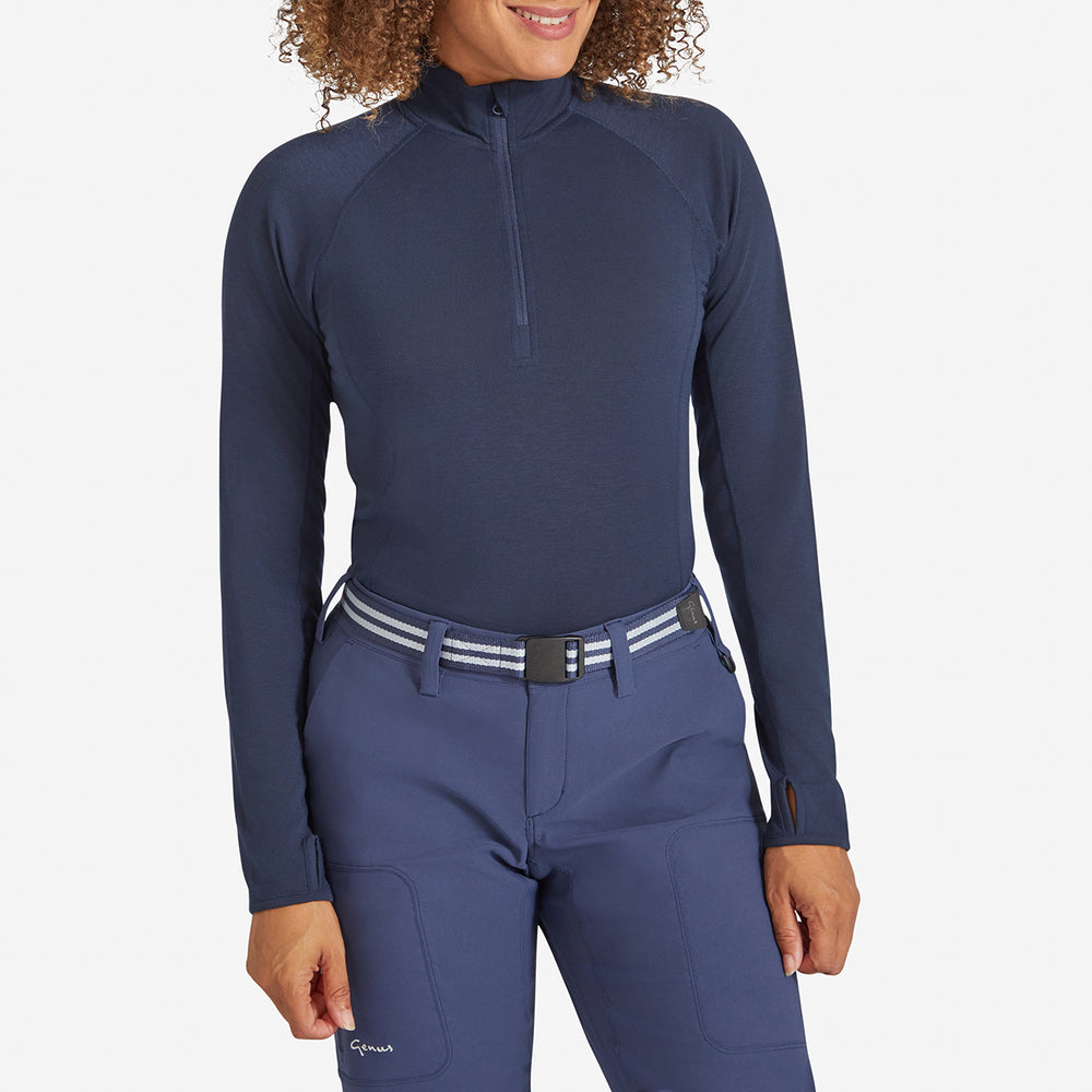 Woman wearing a Genus Women's Marine Blue Eden Zip neck Top tucked in