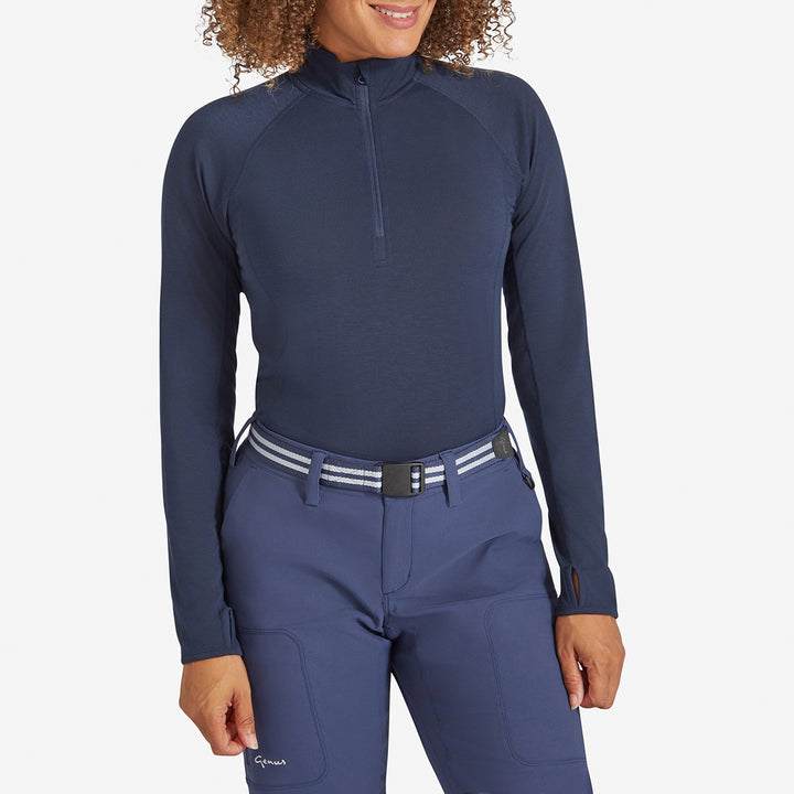 Woman wearing a Genus Women's Marine Blue Eden Zip neck Top tucked in